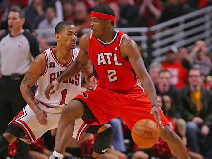 May 2, 2011; Chicago, IL, USA; Atlanta Hawks shooting guard Joe Johnson (2) is defended by Chicago Bulls point guard Derrick Rose (1) during the second half in game one of the second round of the 2011 NBA playoffs at the United Center.